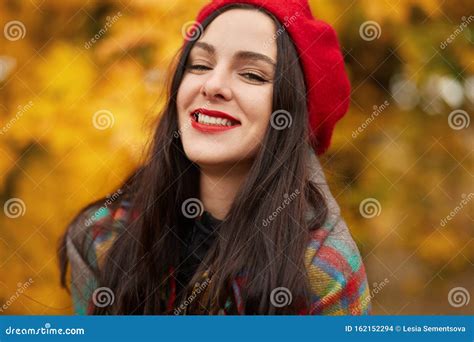 Horizontal Shot Of Happy Beautiful Woman Wearing Red Beret And Wrapped