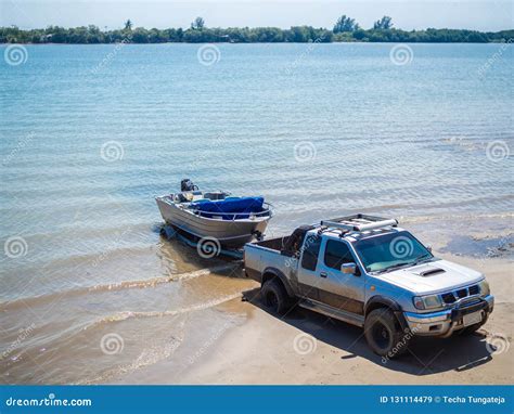 Motor Boat Being Pulled With The Pickup Truck Trailer On The Beach