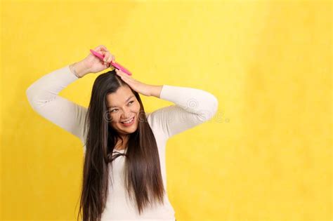 Year Old Latina Woman Cares And Brushes Hair In The Bathroom In A Bathrobe In Front Of The