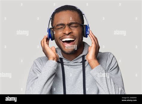 Head Shot Excited African American Man Listening To Music Stock Photo