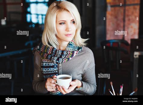 Blonde Girl Sitting In Cafe With Cup Of Tea Stock Photo Alamy