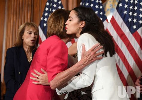 Photo Pelosi And Ocasio Cortez Hug During Swearing In Event