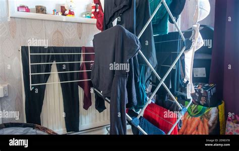 Drying recently washed clothes indoors on a drying rack Stock Photo - Alamy