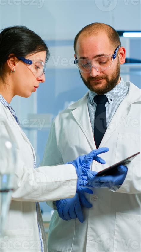 Scientist Team Meeting And Discusssing Treatment Results Standing In
