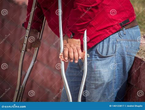 Handicapped With Crutches In The Hands Of The Street Stock Image