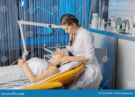 Professional Beautician Makes A Facial Massage To A Woman Stock Image