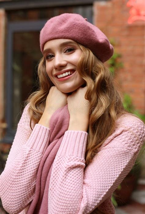 Outdoor Portrait Of Young Beautiful Woman With Long Wavy Hair Wearing Pink Beret And Scarf