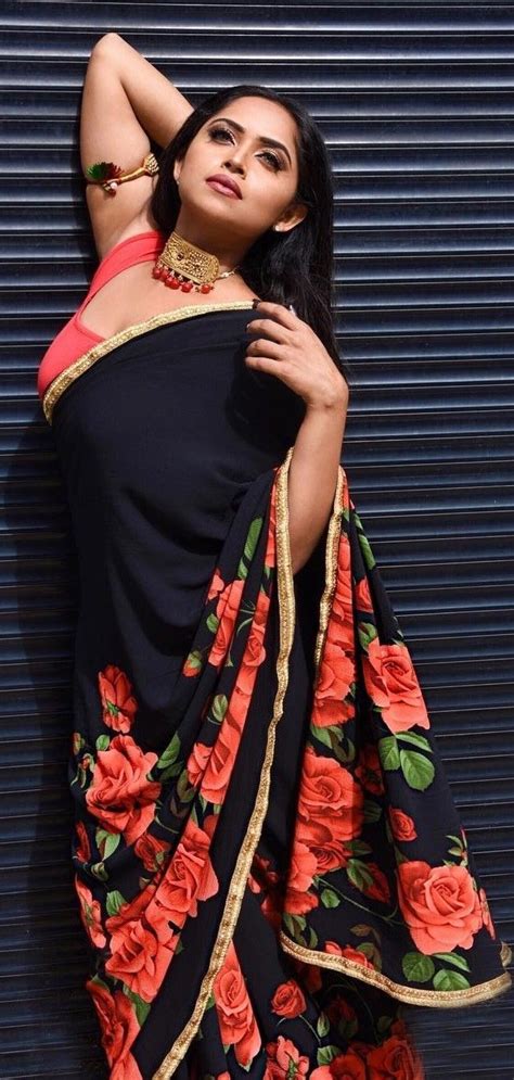 In A Black And Red Color Floral Saree Sleeveless Blouse Design And