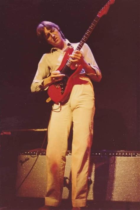 A Man Playing An Electric Guitar On Stage