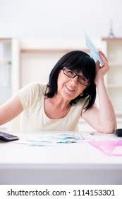 Mature Woman Trying Reconcile Her Bills Stock Photo