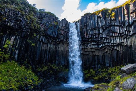 Svartifoss Waterfall in Skaftafell Vatnajokull National Park, Iceland with Green Dramatic ...