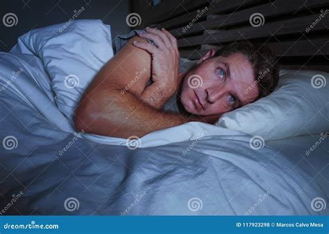 Restless Worried Young Attractive Man Awake At Night Lying On Bed