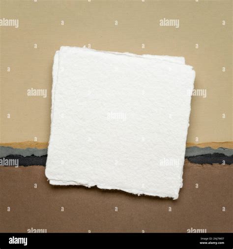 Small Square Sheet Of Blank White Khadi Paper Against Abstract In Earth