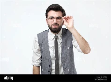 Funny Good Looking Skeptical Man In Glasses Looking At Camera Stock