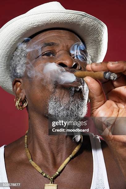 Black People Smoking Cigars Photos And Premium High Res Pictures