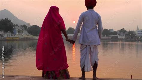 Romantic Indian Couple In Traditional Dress Watching The Sun Go Down On