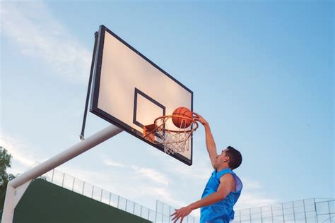 Premium Photo Basketball Street Player Making A Slam Dunk