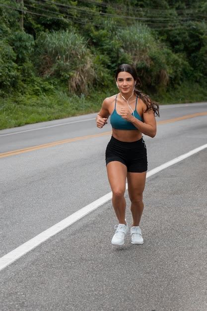 Mulher em forma de tiro completo correndo ao ar livre Foto Grátis