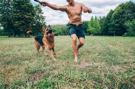 Premium Photo Athletic Guy With A German Shepherd