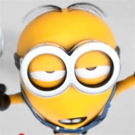 A Yellow Minion With Big Eyes And Headphones Is Holding Up His Arms In