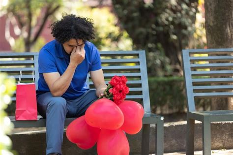Premium Photo Mexican Man Sitting On Park Bench Crying On Valentine