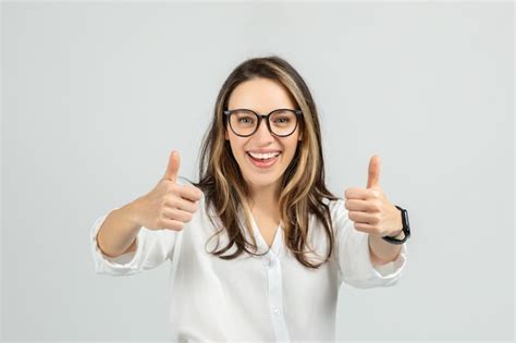 Premium Photo A Smiling Young Woman With Long Hair And Glasses Gives