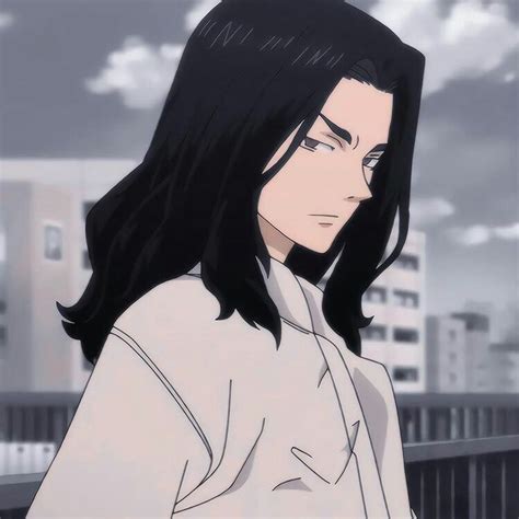 A Man With Long Black Hair Standing In Front Of A Cityscape And Looking