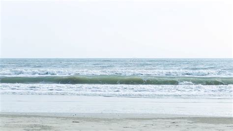 Narrow Beach Line Sea Waves With Wave Crashing On Sandy Shore Stock