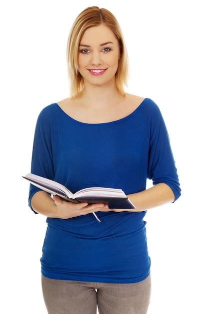 Premium Photo Portrait Of Young Woman Holding Book Against White