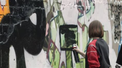Cute Brunette Girl Painting A Graffiti By Stocksy Contributor Luis Velasco Stocksy