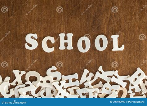 The Word School Made Of Wooden Letters On A Wooden Background Top View