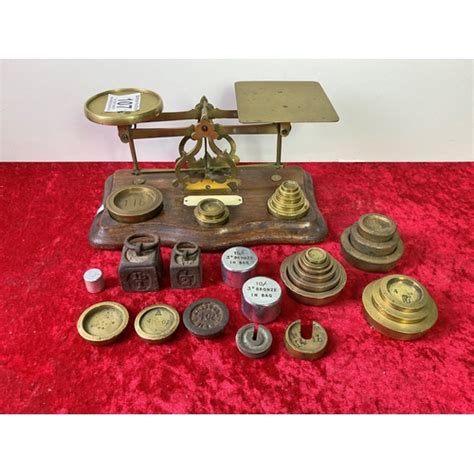 Set Of Brass Scales On A Wooden Base With A Quantity Of Brass Weights