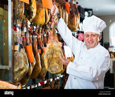 Portrait Of Cheerful Smiling Positive Mature Shop Man Offering Spanish