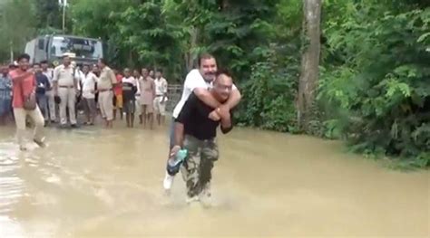 Viral Video Shows Assam Bjp Mla Taking Piggyback Ride While Inspecting