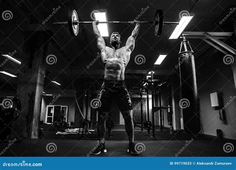 Muscular Man At A Crossfit Gym Lifting A Barbell Stock Image Image