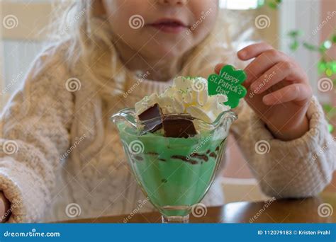 Child Eating an Ice Cream Sundae Treat for St. Patrick`s Day Stock ...