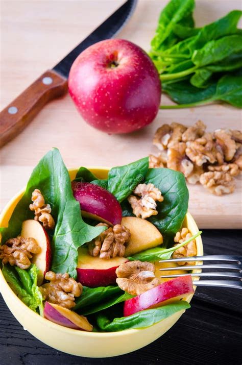 The Spinach Salad with Nuts and Apples Served on Table Stock Photo ...