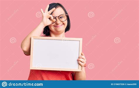 Brunette Woman With Down Syndrome Holding Empty White Chalkboard
