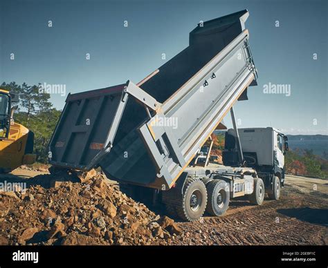 Dump Truck Unloads Soil From Truck Back Stock Photo Alamy