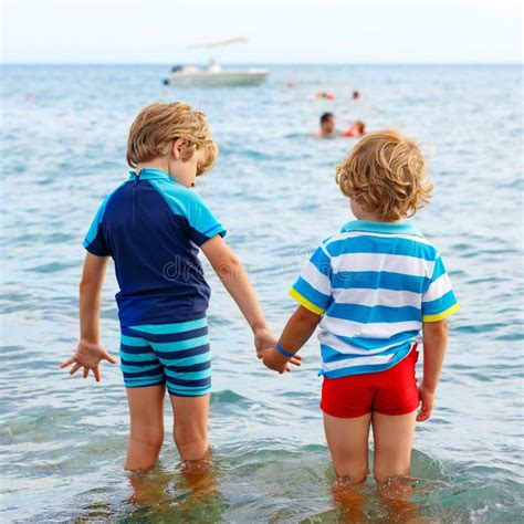 Dos Muchachos Del Niño Que Toman El Baño En El Océano Foto de archivo