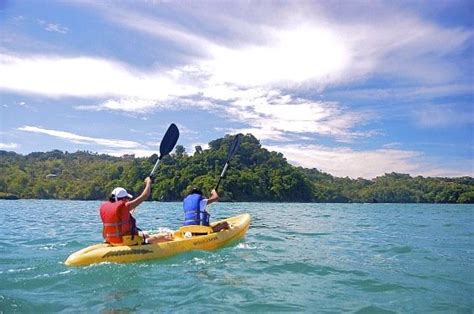 Two People In Kayaks Paddling On The Water