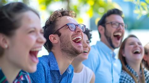 Group Of Coworkers Shares A Hearty Laugh While Gathered In A Welllit