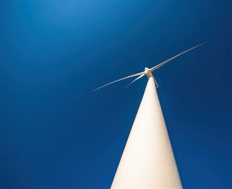 Premium Photo Close Up Of Wind Turbine Against Blue Sky Copy Space