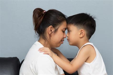 Premium Photo Side View Of Mother And Son Touching Foreheads At Home