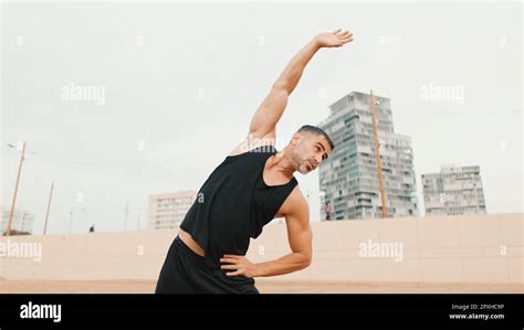 Mature Man Doing Stretching Exercises Before Main Workout While