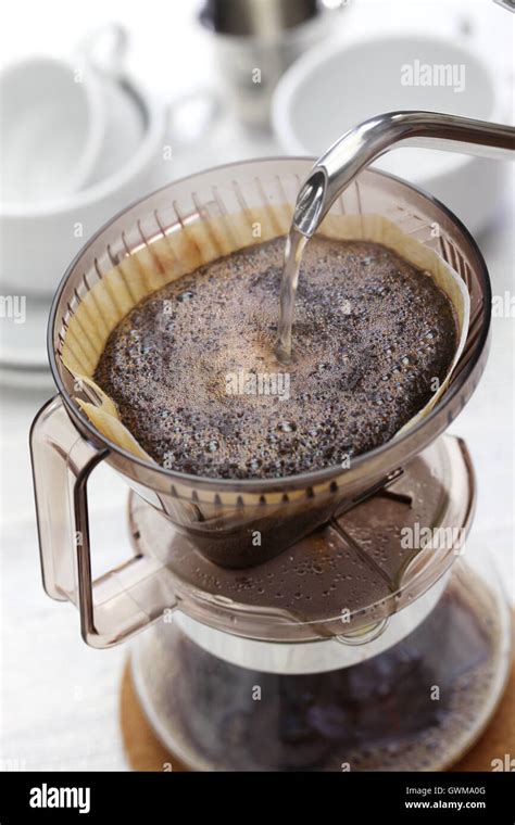 Drip Coffee Making With A Funnel Shaped Filter Paper On A Glass Vessel