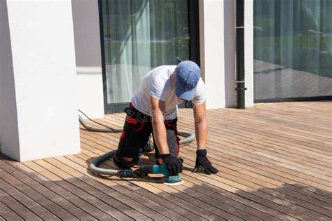 Deck Builder Sanding Ipe Wood Boards With The Professional Orbital