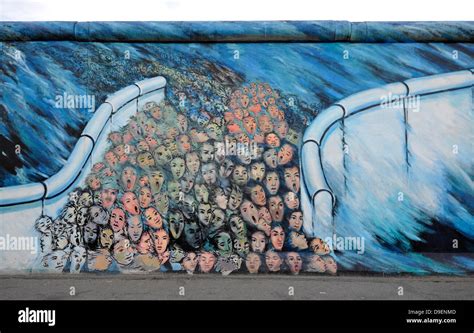 Art and Berlin Wall human masses break through the Berlin Wall Fall of the Wall painting in a ...