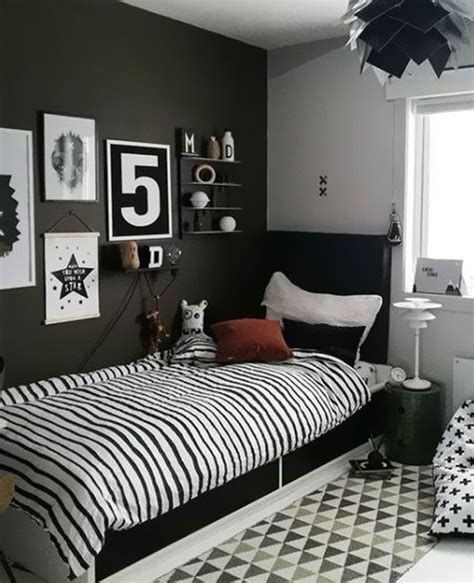 A Bed Room With A Neatly Made Bed And Lots Of Pictures On The Wall Above It