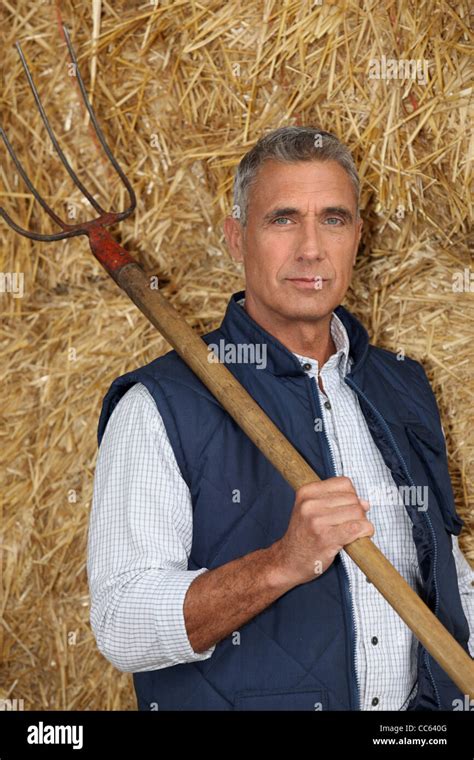 Farmer Holding A Pitchfork Stock Photo Alamy